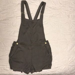 Green overalls with gold side buttons